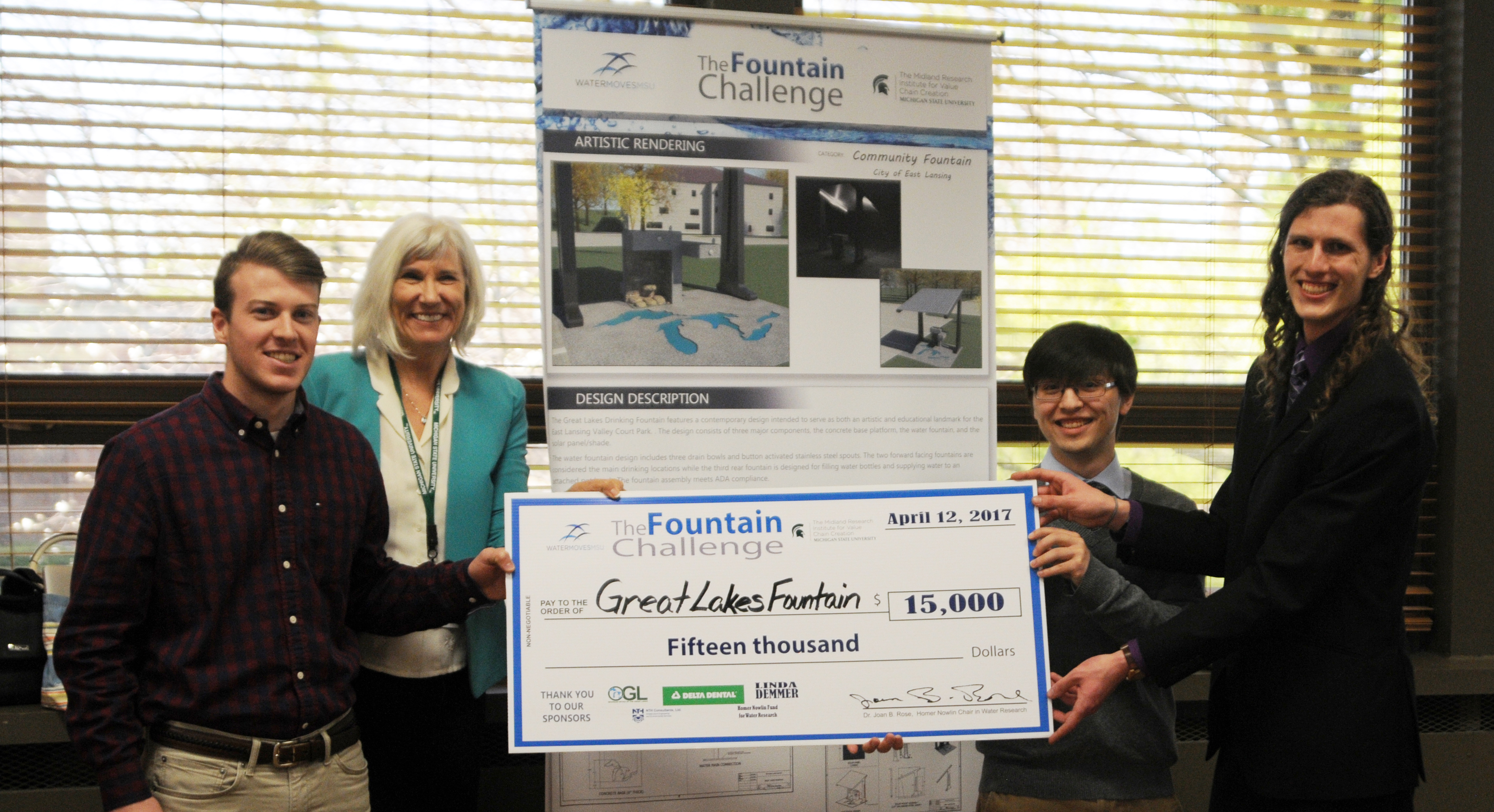 A photo of the winners of the Fountain Challenging holding their prize check for $15,000.
