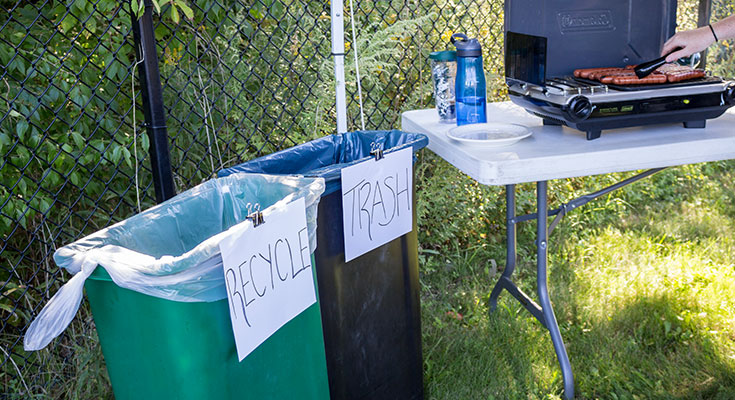 A photo of makeshift recycling containers at a tailgate.