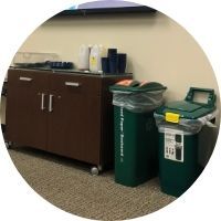 Photo of reusable cups and recycling-composting station at a meeting..